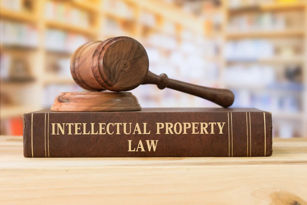 Intellectual Property law books and a gavel on desk in the library. concept of legal education.