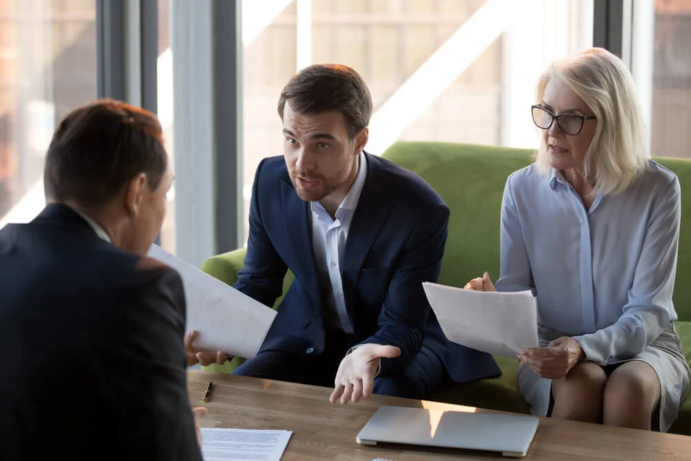 Concerned businesspeople argue with colleague or client dissatisfied with contract terms, mad worried businessman have dispute with business partner unhappy with agreement, claiming money back