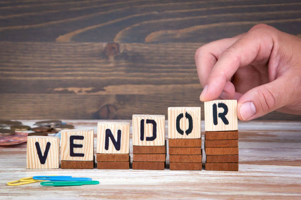 Vendor concept. Wooden letters on the office desk, informative and communication background