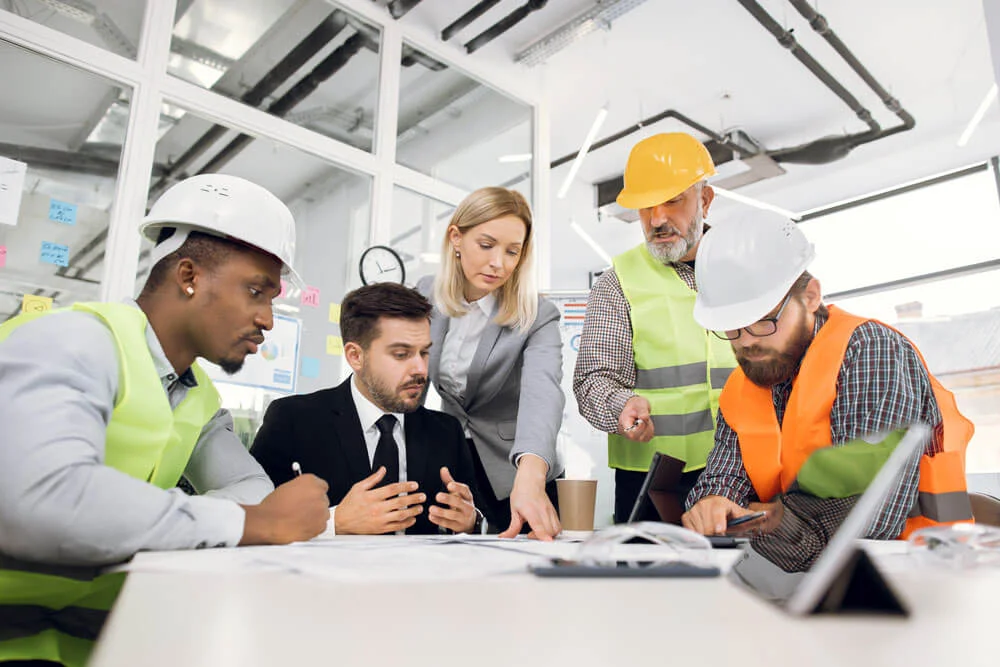 Concentrated professional multiracial team of male and female engineers or architects