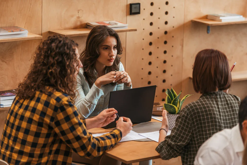 Employees having meeting at table in the cafe