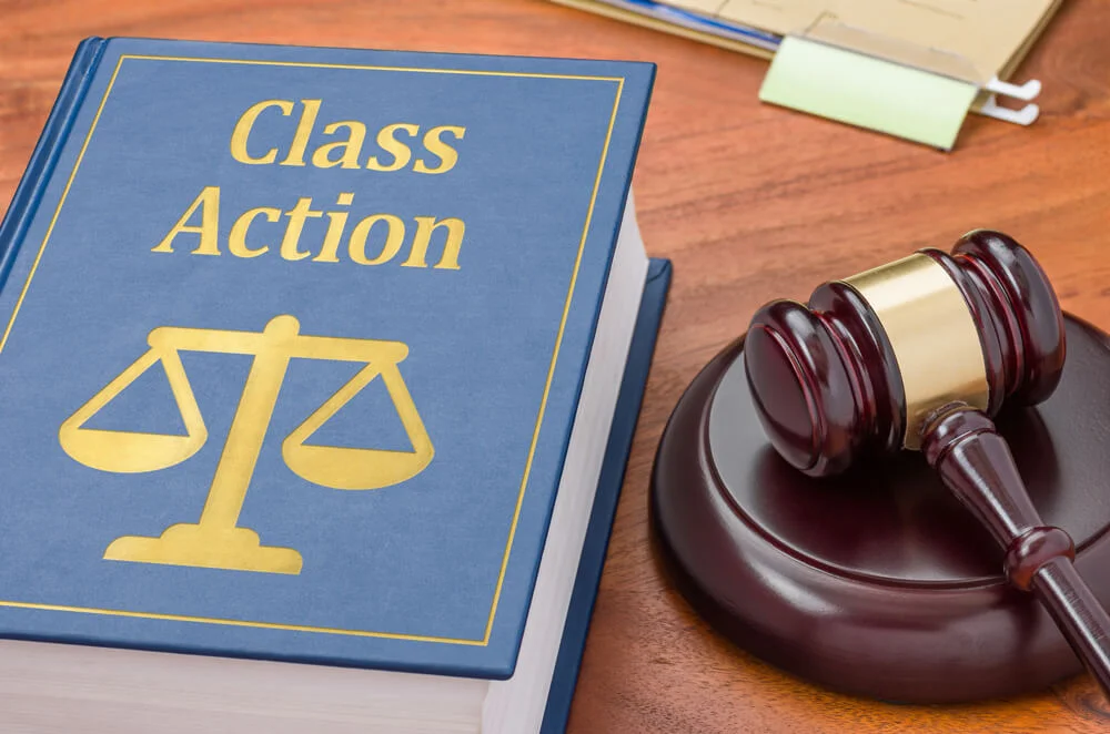 A law book with a gavel - Class action