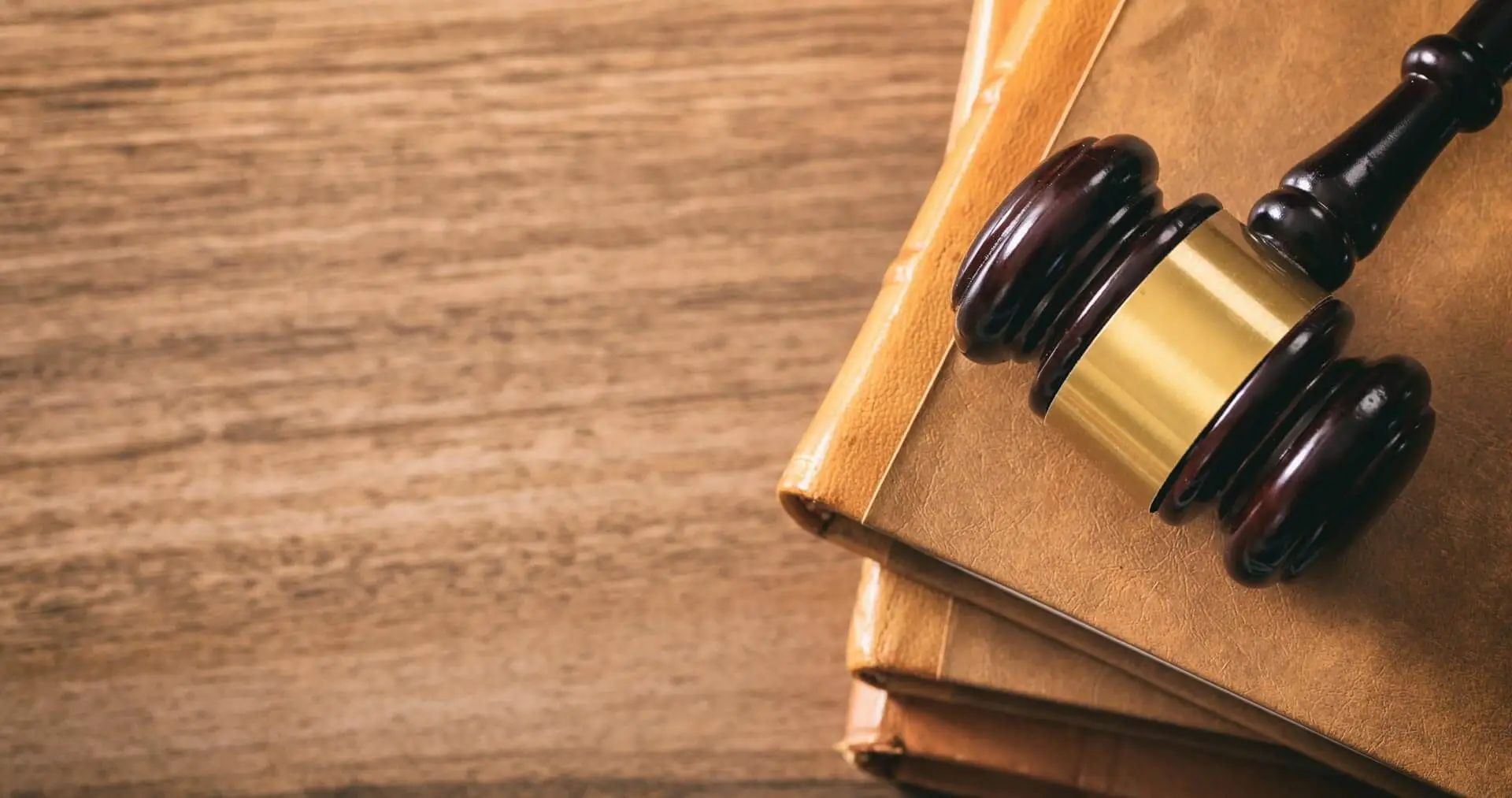 Law theme, lawyer's desk. Judge gavel on legal books, wooden background, copy space, top view