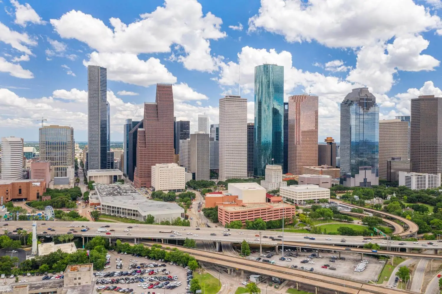 Sky drone view of downtown Houston during day with cityscape and highway in view