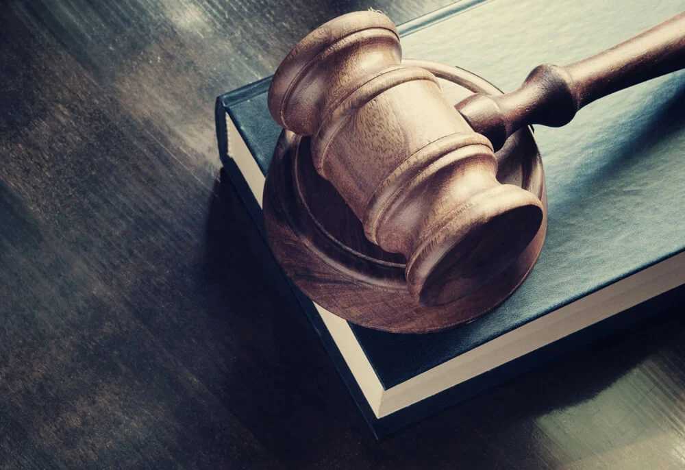 Judge gavel and legal book on wooden table, justice and law concept